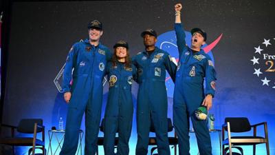 Jeremy Hansen, Christina Koch, Victor Glover and Reid Wiseman wave to the crowd the day after splashing down in the Pacific Ocean, at Ellington Field Joint Reserve Base in Houston, Texas, U.S. April 11, 2026.