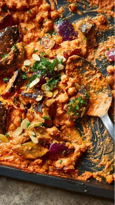 A top down view of a baking tray with chickpea romescu traybake