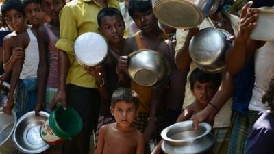 Indian villagers queue for food at the flood-hit Dagrua village