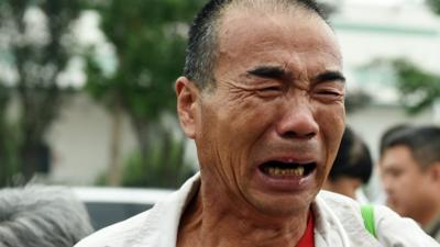 A relative of a passenger on missing Malaysia Airlines MH370 cries while waiting for an expected meeting with Malaysian officials