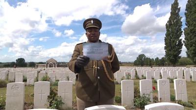 A serviceman reads out the name of a man who was killed in the Passchendaele battle