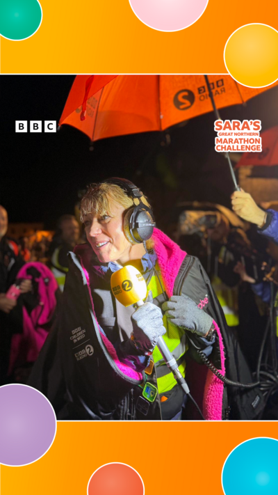 Sara Cox holding a microphone