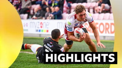 Caleb Aekins of Bradford fails to stop Noah Hodkinson of Wigan from scoring a try