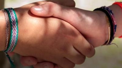 A close-up of a hand-shake.