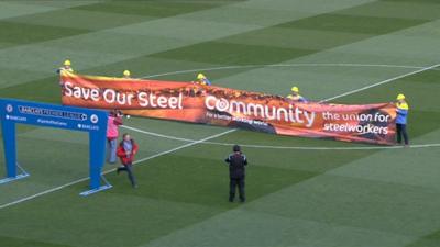 Steelworkers parade their banner at the Swansea City v Chelsea match