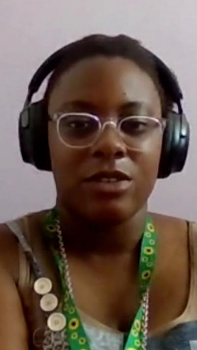 Savanna Cumberbatch wearing glasses and eaphones speaking into a webcam