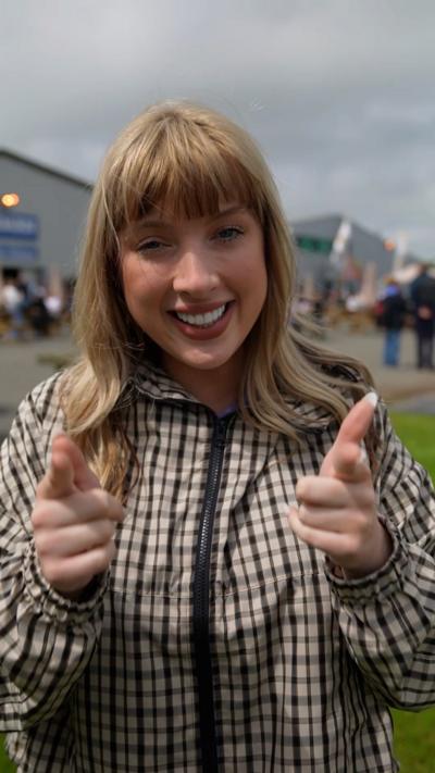 Katie Owen who has blonde hair and a fringe in a checkered coat
