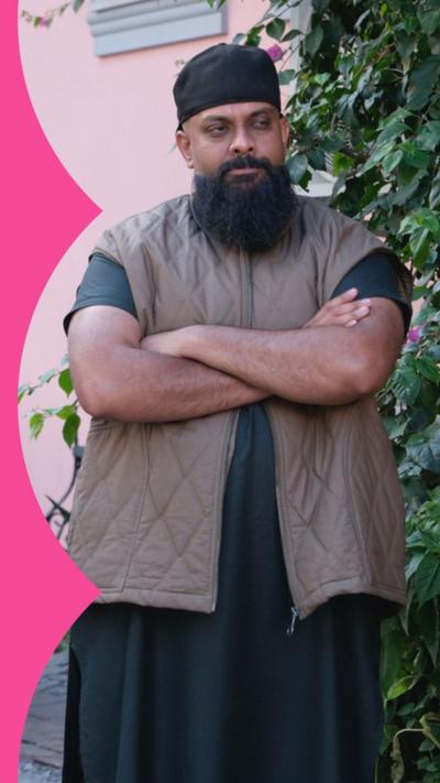 Man stood looking annoyed with crossed arms