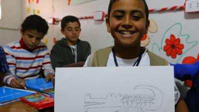 Syrian refugee with his drawing