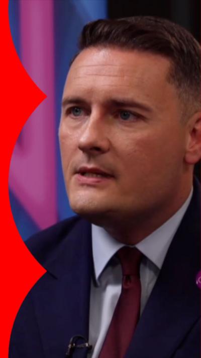 Wes Streeting wearing a navy blazer and red tie with a white shirt.