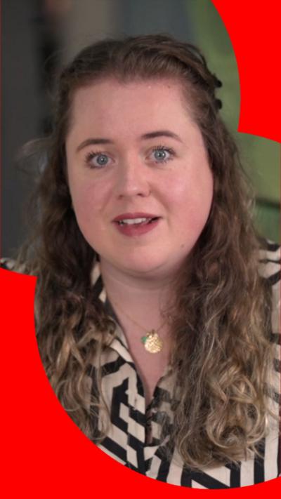 A woman with light brown hair wearing a black and white striped shirt.