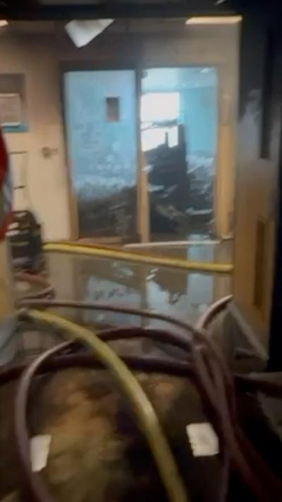 Inside of a hospital ward covered in soot after a fire. 