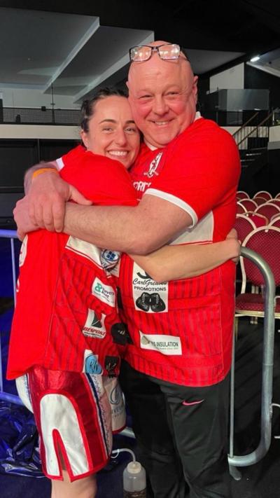 Jade Pearce being hugged by her dad John