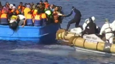 Italian Navy rescue migrants from a crowded boat off the coast of Libya