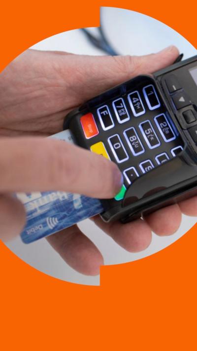 A person's hand using a card payment reader