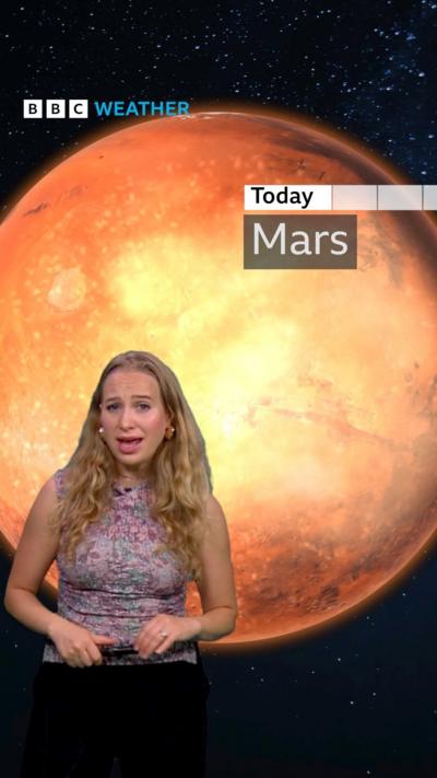 Sophia Herod standing in front of an image of Mars