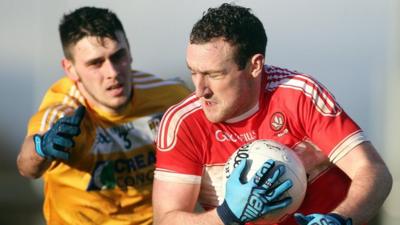 Antrim's Conor Burke tackles Derry's man of the match Shane Heavron at Owenbeg