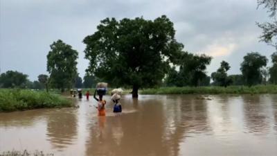 Women wading through water