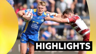 Leeds player James McDonnell holding off a tackle with the ball in his arm