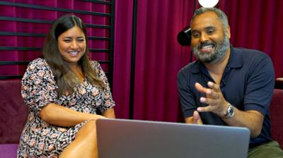 Rhianna Dhillon and Marc Cieslak sitting and looking at a laptop