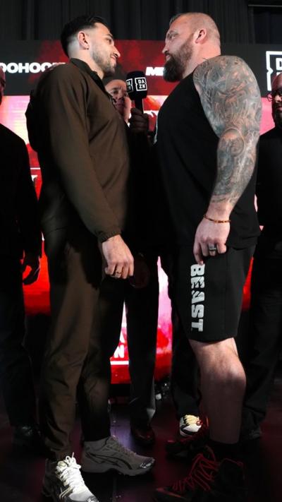 Tommy Fury and Eddie Hall stood facing each other
