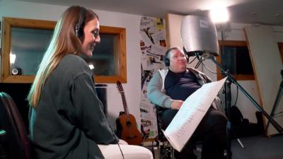 woman and man in recording studio