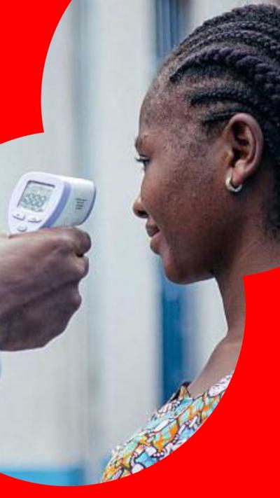 Woman has her temperature checked.