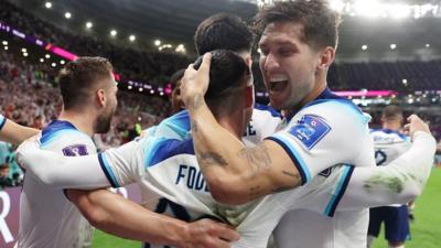 England's John Stones hugs Phil Foden