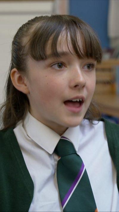 School girl with brown hair speaking