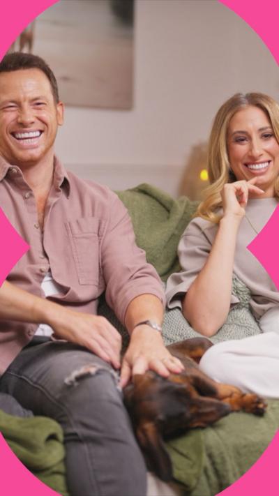 Stacey and Joe sat on a sofa and laughing
