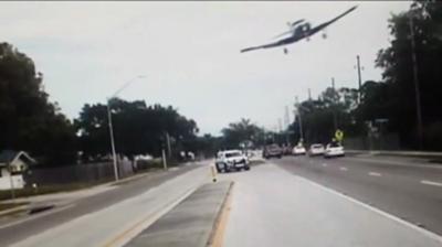 Plane flying above highway