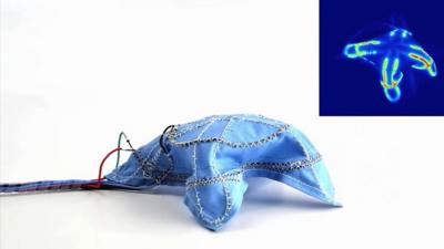 A blue fabric connected to wires that is forming a raised shape