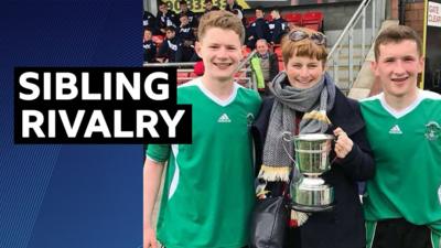 Bobby Burns and Paddy Burns pose after winning a trophy