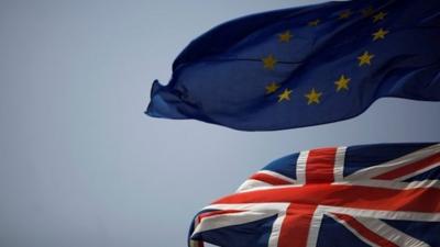 The Union Jack (bottom) and the European Union flag are seen flying