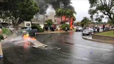 A man puts out fire on a piece of debris from the plane