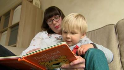 Mother reading to toddler