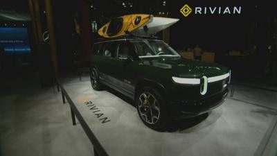 Green Rivian electric truck on show stand