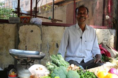 Street seller sitting cross legged on Mumbai street