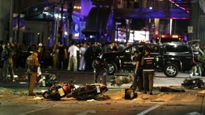 Motorcycles lie on the street at the scene of a bomb attack near Erawan Shrine, central Bangkok, Thailand