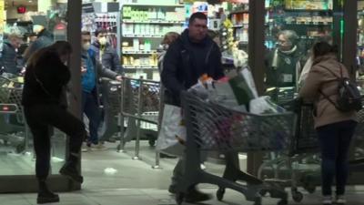 Shoppers at a crowded Rome supermarket