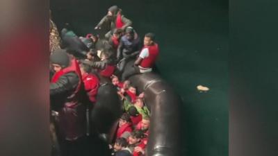 Migrants struggling to escape a sinking boat