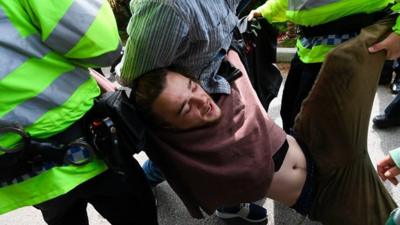 Protester Conor being arrested at Theresa May's manifesto speech