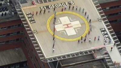 People applauding on helipad