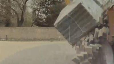 The £50,000 car was written off when a load of slabs fell from a lorry on a bend in the road.