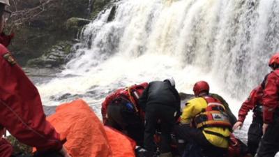 A man and woman are seriously injured after being washed over a waterfall in the Brecon Beacons national park in Wales