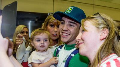 Michael Conlan poses for photographs at Dublin Airport following his return from the Olympic Games