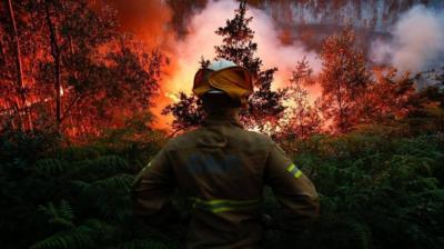 A fireman fights the forest fire in Portugal