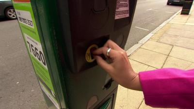 New pound coin being used in parking machine