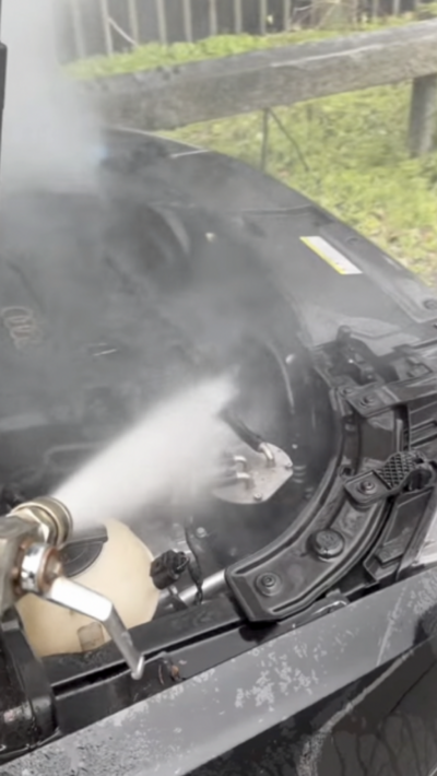 Jet wash firing water at car engine