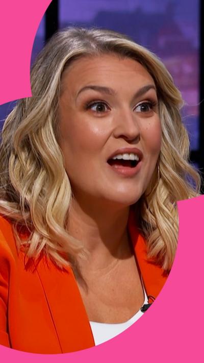 Dragon Sara Davies has shoulder length wavy blond hair and wears an orange blazer over a white top